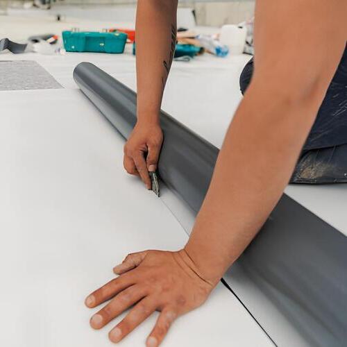a worker installing a TPO roof