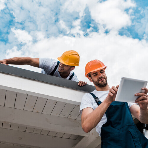 two inspectors checking a roof