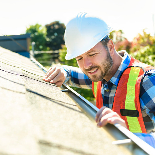 a roofer inspecting a roof for an insurance claim