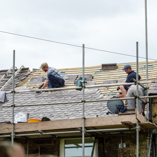 roof being restored with workers on it